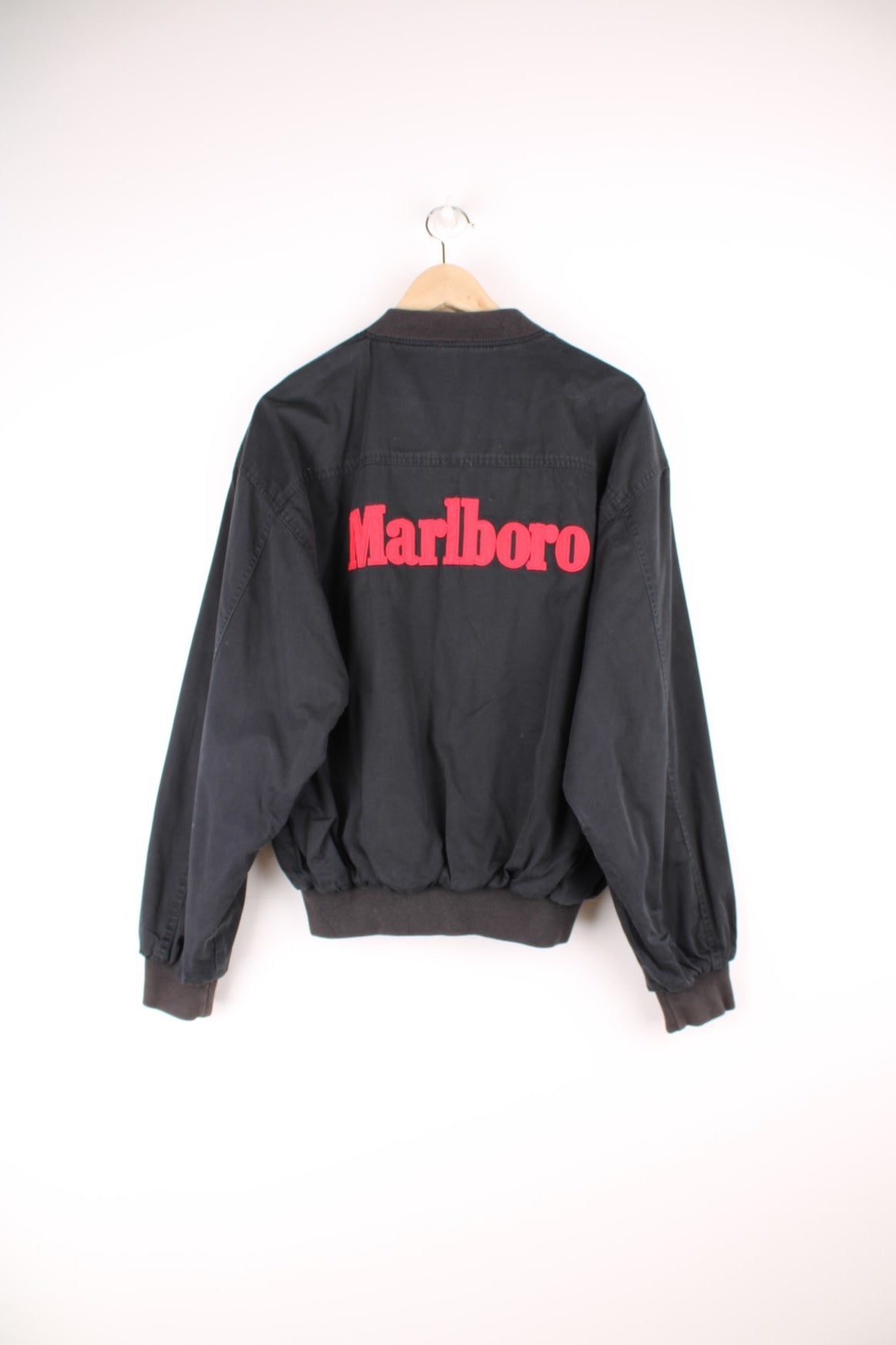 Vintage Marlboro reversible bomber jacket in red and black. Features embroidered spell out logo on the back, and embroidered "M" on the sleeve. 