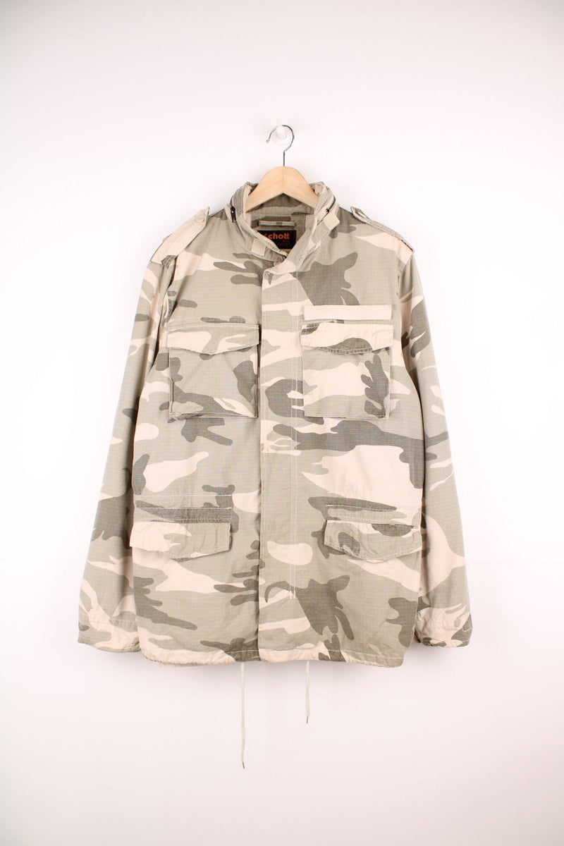 Schott NYC camouflage zip through jacket with a pack away hood, multiple pockets and a removable velcro strip above the pocket.