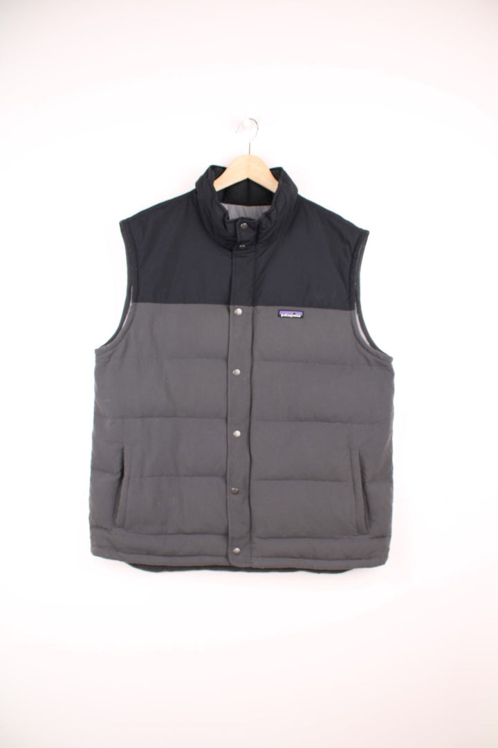 Grey and black Patagonia puffer gilet with zip and snap closure and slit pockets. 