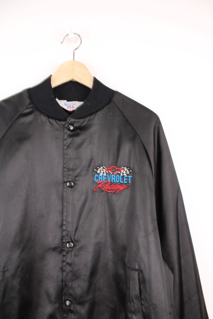 Black Chevrolet Racing bomber jacket by West Ark USA. Snap closure and front and back logo embroidery in red, white and blue. 