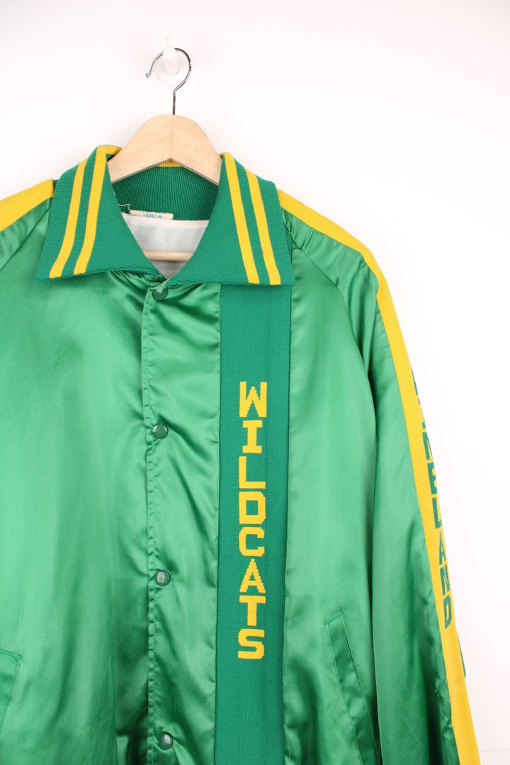 Green and yellow Pineland Wildcats bomber jacket with snap closure and side pockets.