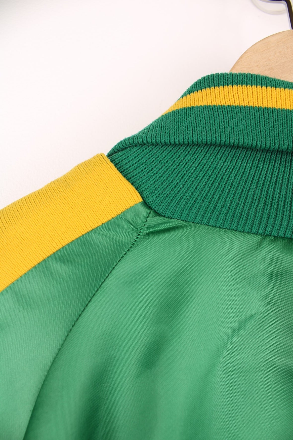 Green and yellow Pineland Wildcats bomber jacket with snap closure and side pockets.