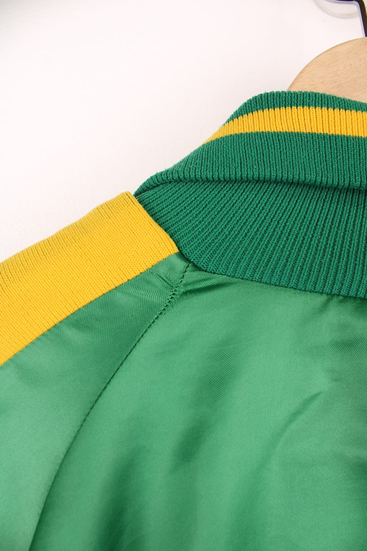 Green and yellow Pineland Wildcats bomber jacket with snap closure and side pockets.