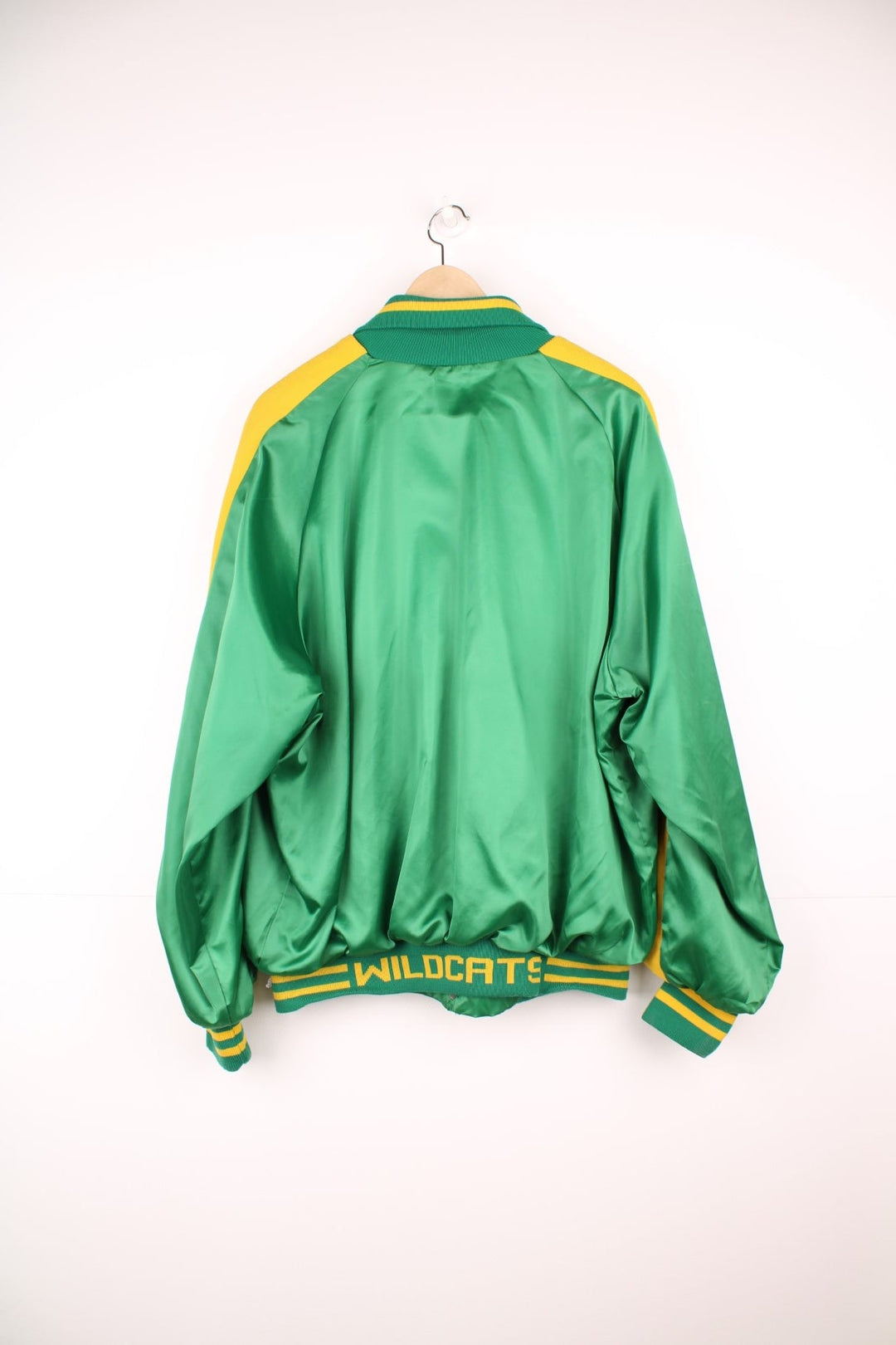 Green and yellow Pineland Wildcats bomber jacket with snap closure and side pockets.