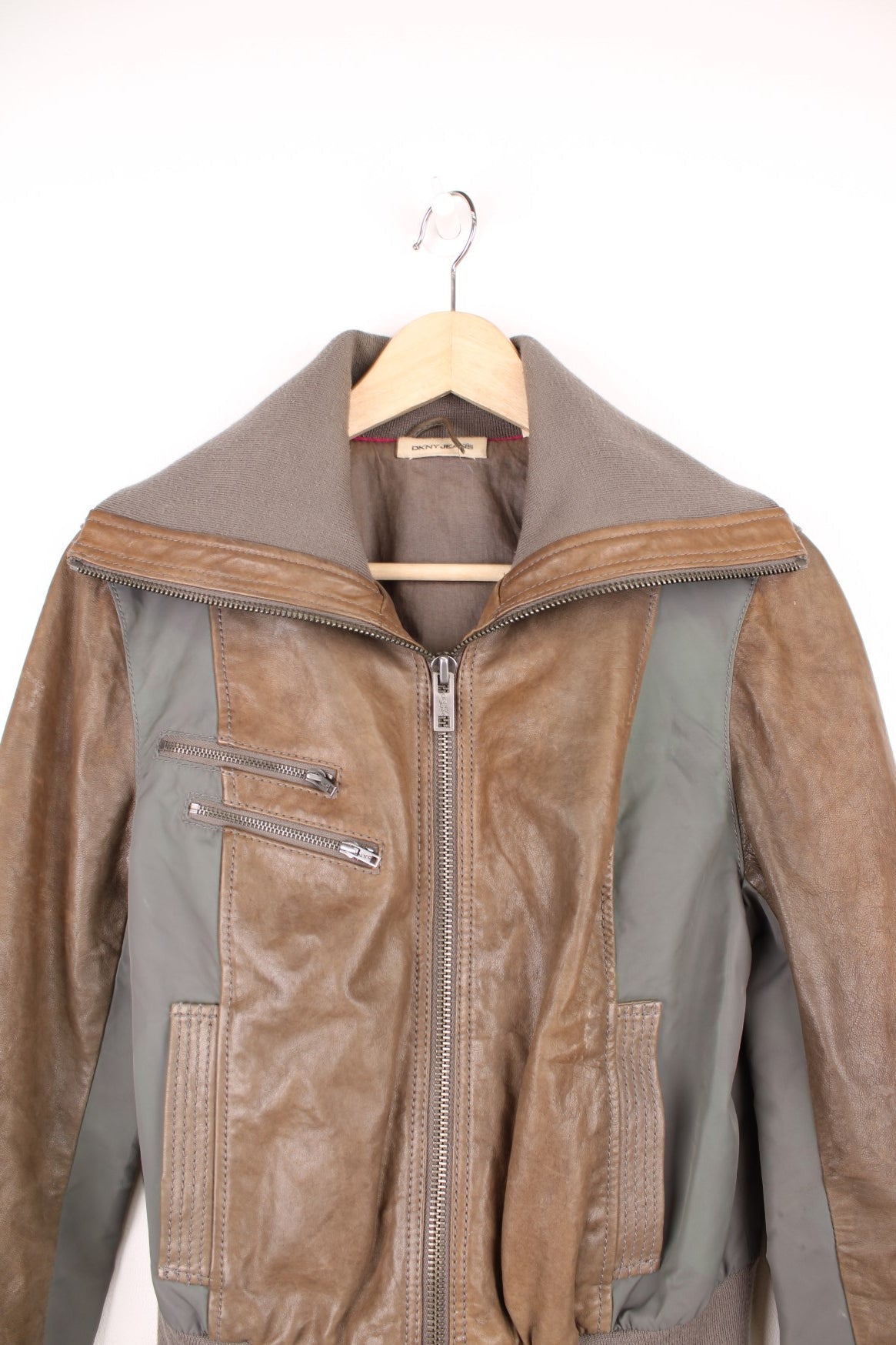 DKNY brown and grey panelled leather bomber jacket with zip closure and four pockets.  