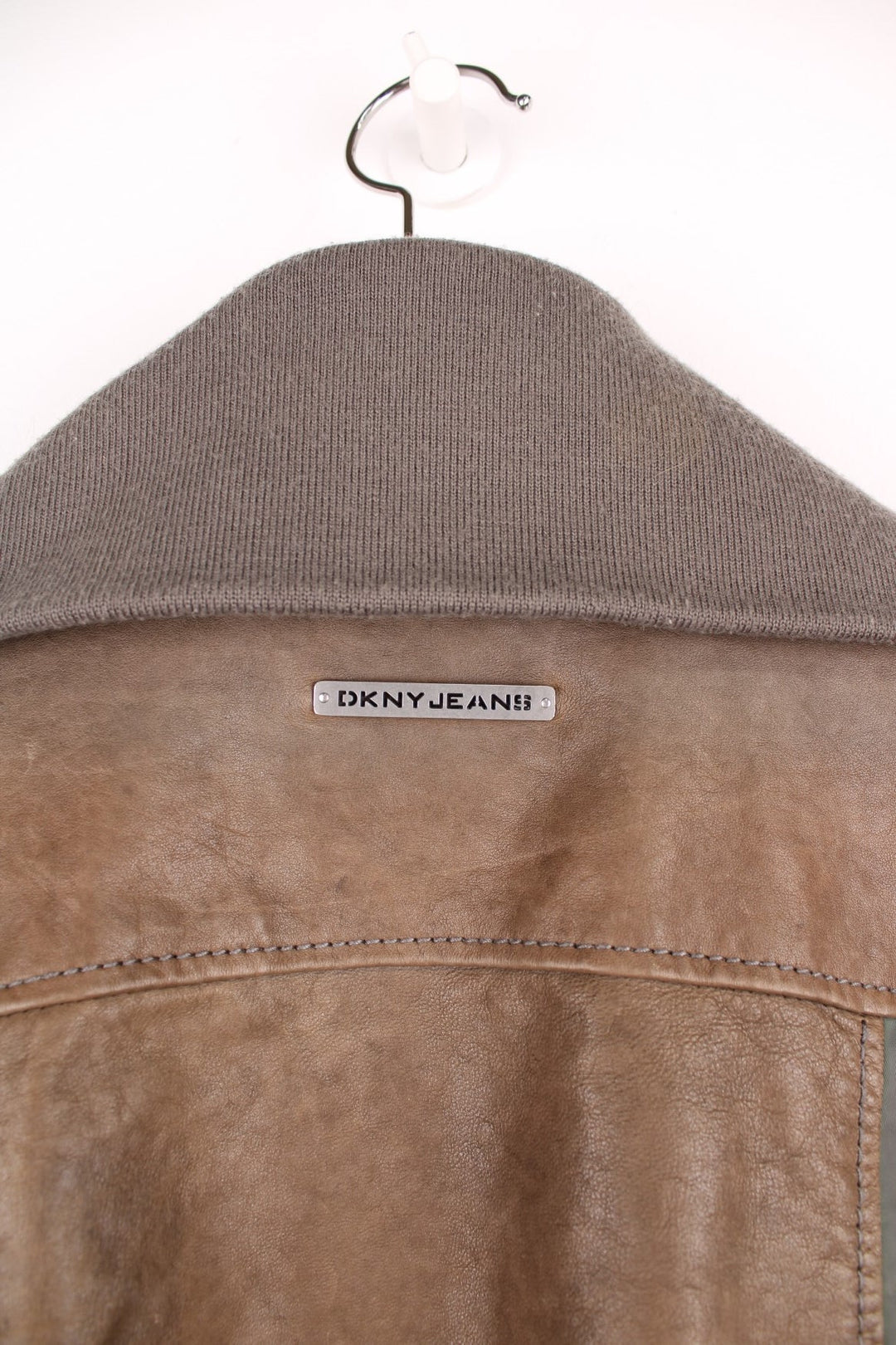 DKNY brown and grey panelled leather bomber jacket with zip closure and four pockets.  