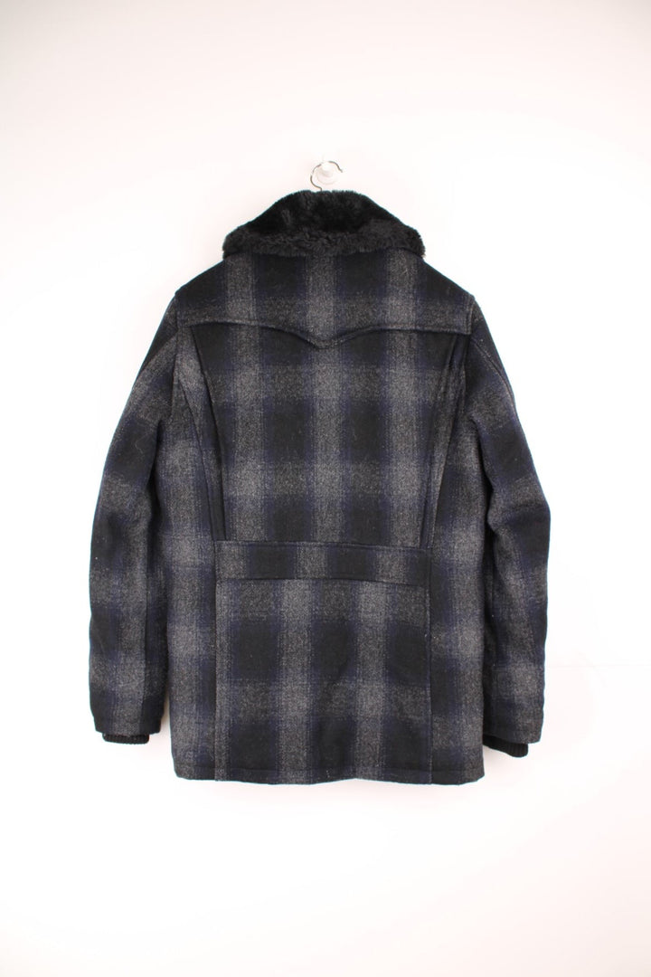 Schott Rancher coat in navy blue check with black faux fur collar, button closure, four pockets, and 'Schott' embroidered on the sleeve. 