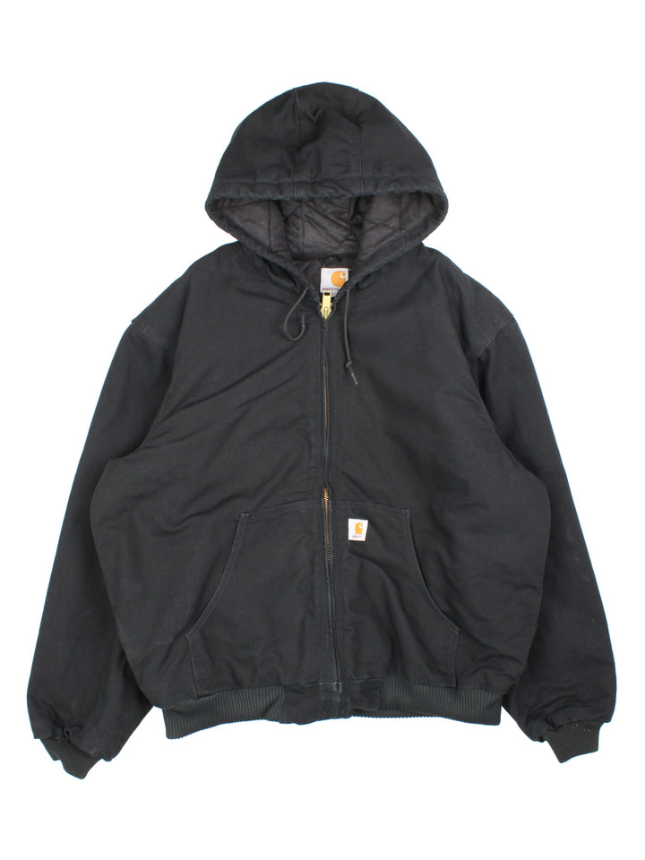 Vintage Carhartt Active Jacket in a black colourway. Zip up fastening, with hood and x 2 front pockets. Quilted lining with x 2 interior pockets and Carhartt branding on front. 