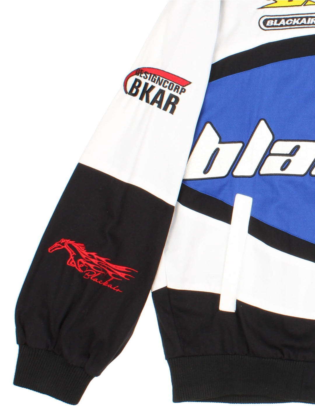 Vintage Blackair Nascar Jacket in a white, blue and black colourway. Buttons up and has side pockets, and all over embroidered logo detailing.