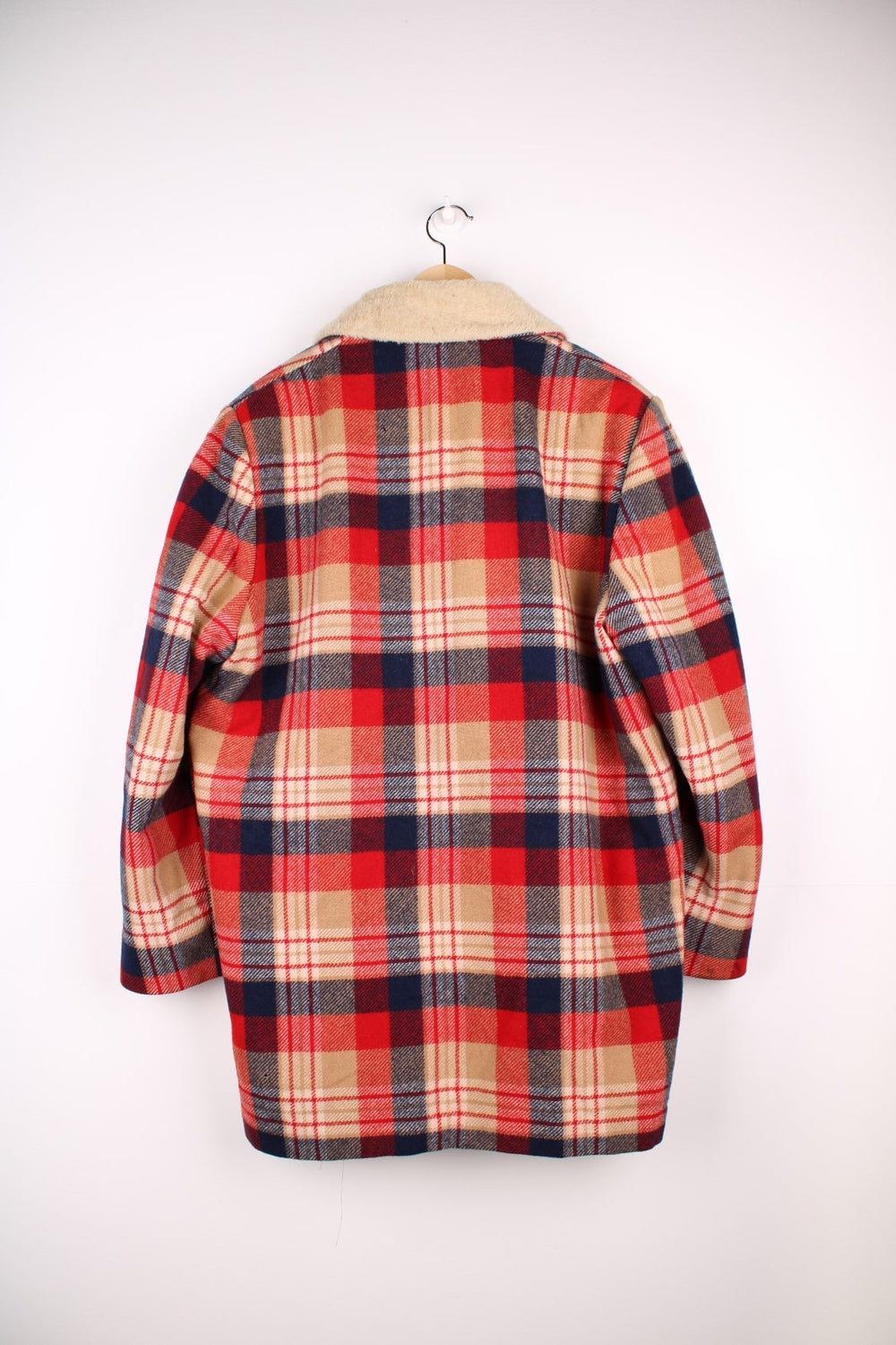 Vintage Pendleton coat in a red navy and cream checked Wool. The jacket has a faux fur collar, is lined with a quilted polyester, and has 2 jetted pockets on the front panels. Made in the USA. 