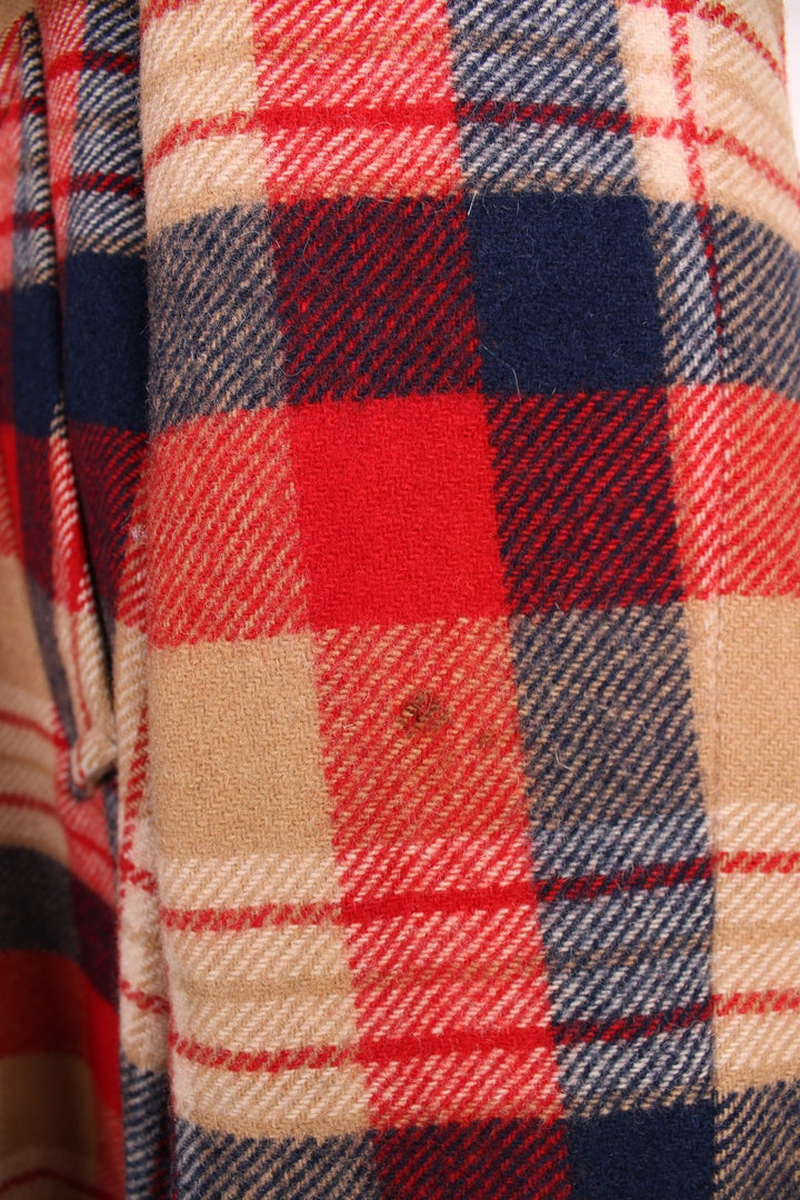 Vintage Pendleton coat in a red navy and cream checked Wool. The jacket has a faux fur collar, is lined with a quilted polyester, and has 2 jetted pockets on the front panels. Made in the USA. 