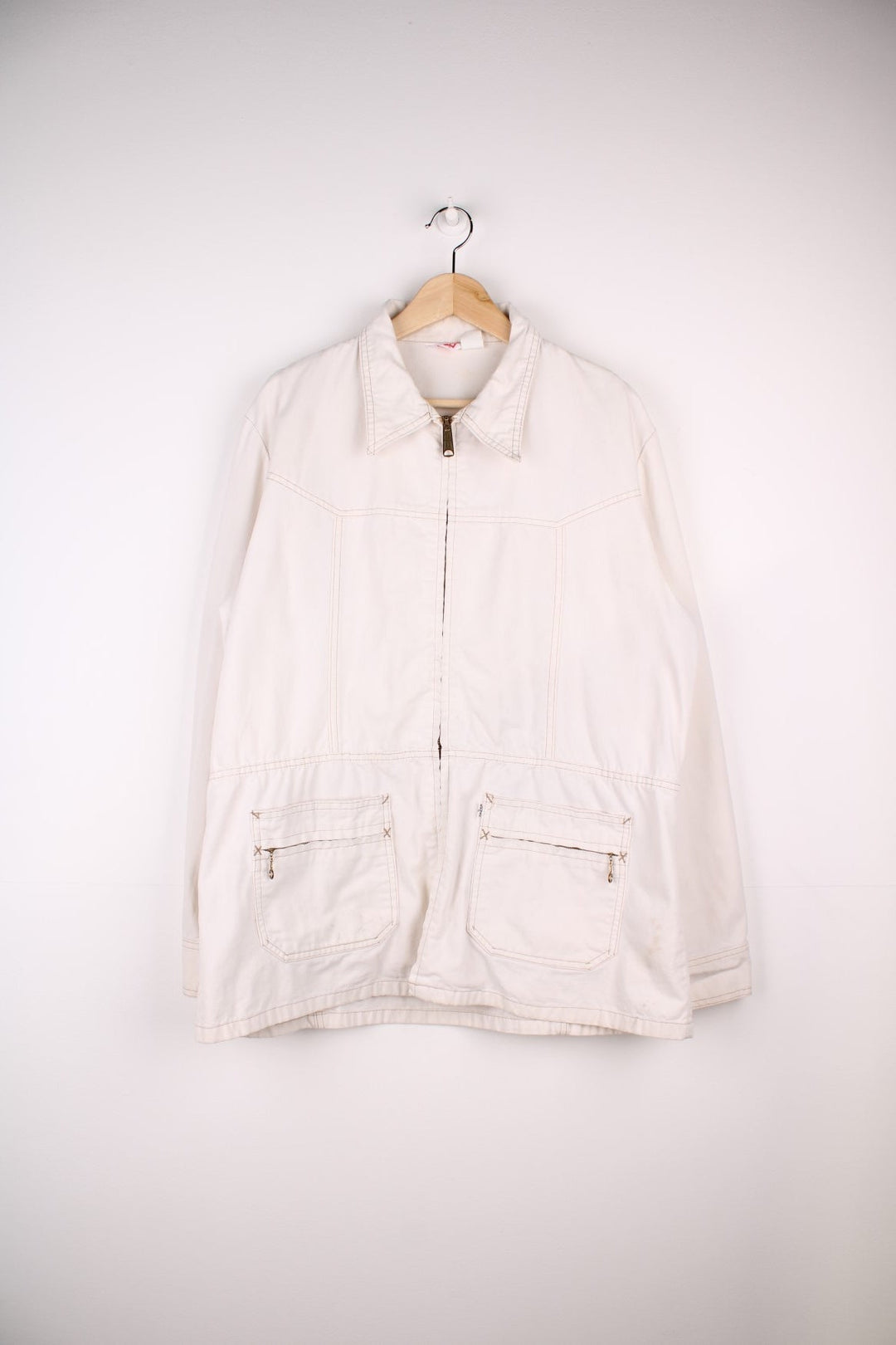 Vintage Levi Strauss chore jacket in an off white / cream colourway. Has a dagger collar and two zip pockets. Made in the USA. 