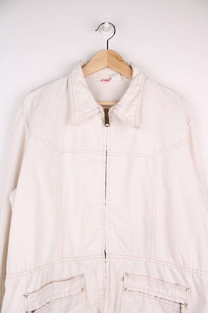 Vintage Levi Strauss chore jacket in an off white / cream colourway. Has a dagger collar and two zip pockets. Made in the USA. 