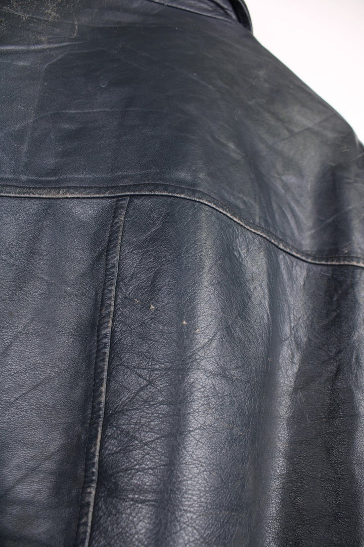 Vintage leather jacket in a dark navy blue colourway. The jacket has an Orillia Travelways patch, who were an Ice Hockey team based in Ontario Canada. It also has press studs to close, and jetted pockets on the front. Dates between 1970-78. Made in Canada. 