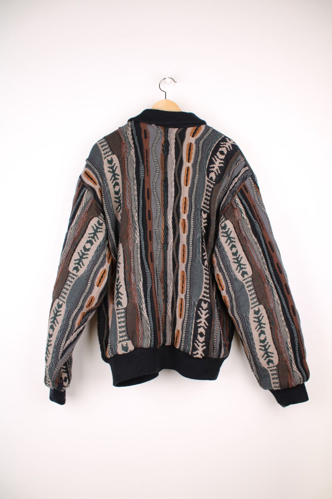 Vintage Pagani knitted and suede bomber jacket, in a black and brown colourway. The jacket has suede panels on the front, leather patches on the shoulders and 3D knit sleeves and back panels.  