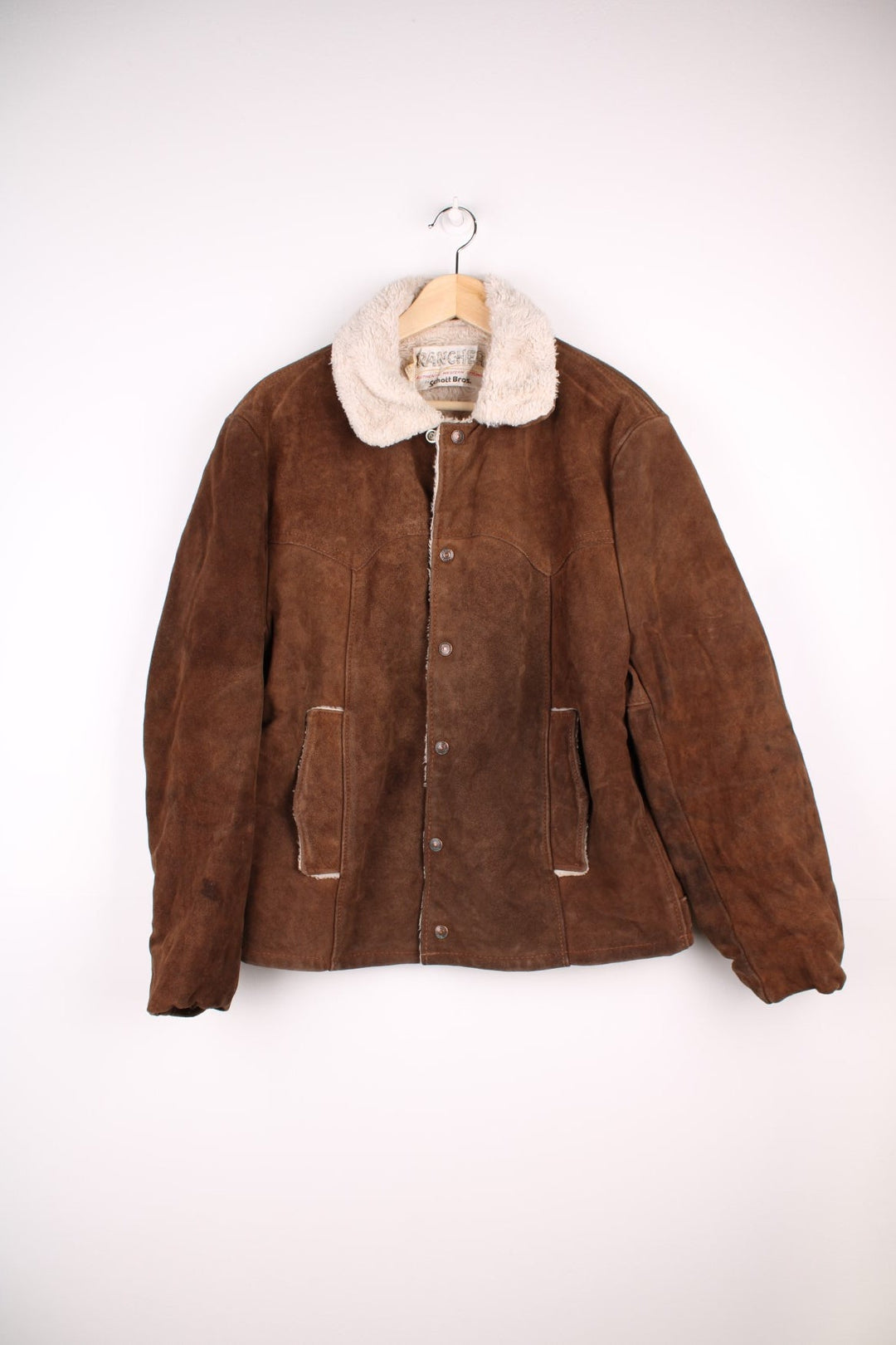 Vintage Schott Rancher Suede Trucker Jacket in brown. The jacket is fully lined with a cream fleece, has a western style yolk panelled front, and press studs to close.  