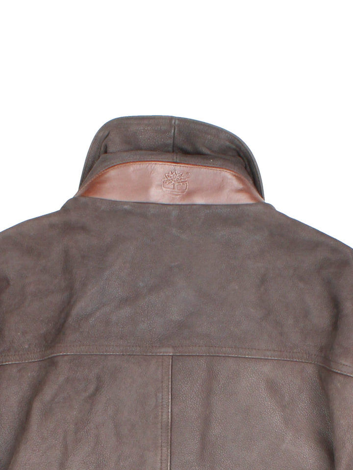 Timberland leather jacket in brown with multiple pockets, zip closure, and ribbed collar and cuffs.