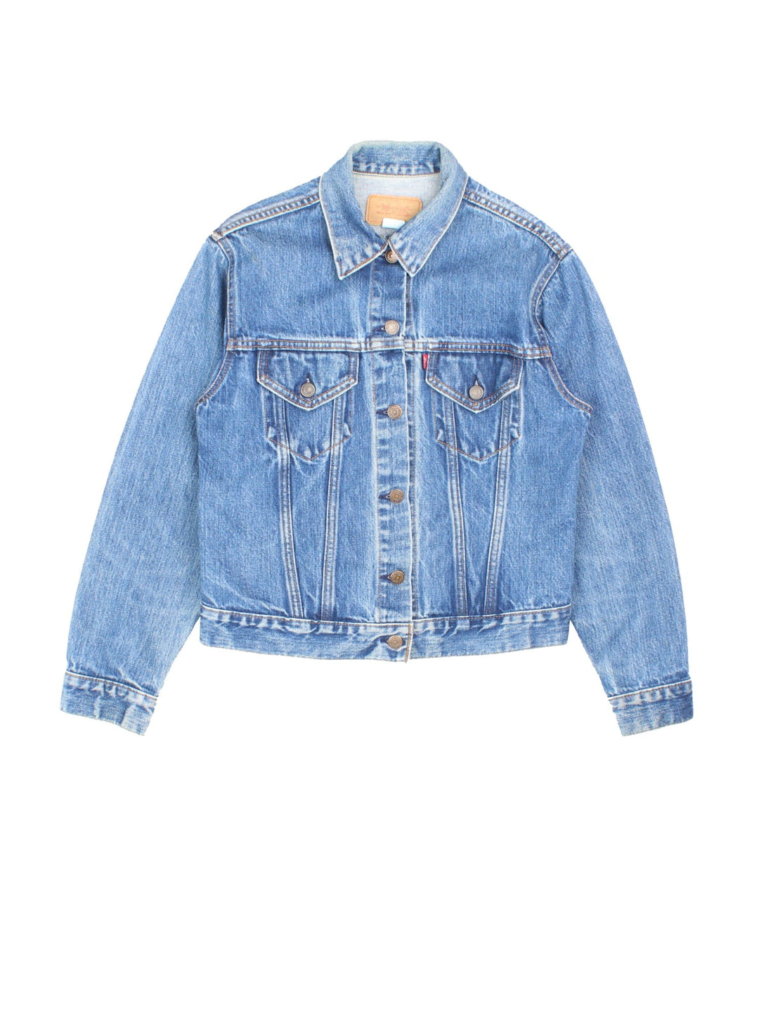 Levi Strauss trucker denim jacket in blue with two pockets, button closure, and a red tab on the front.