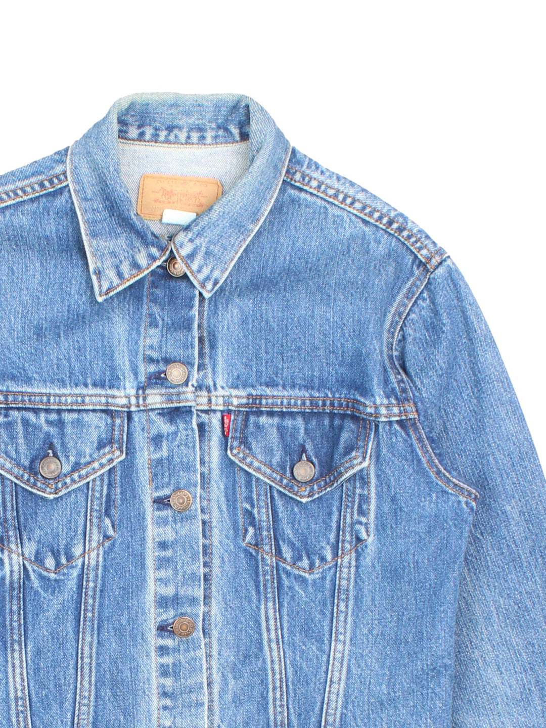 Levi Strauss trucker denim jacket in blue with two pockets, button closure, and a red tab on the front.