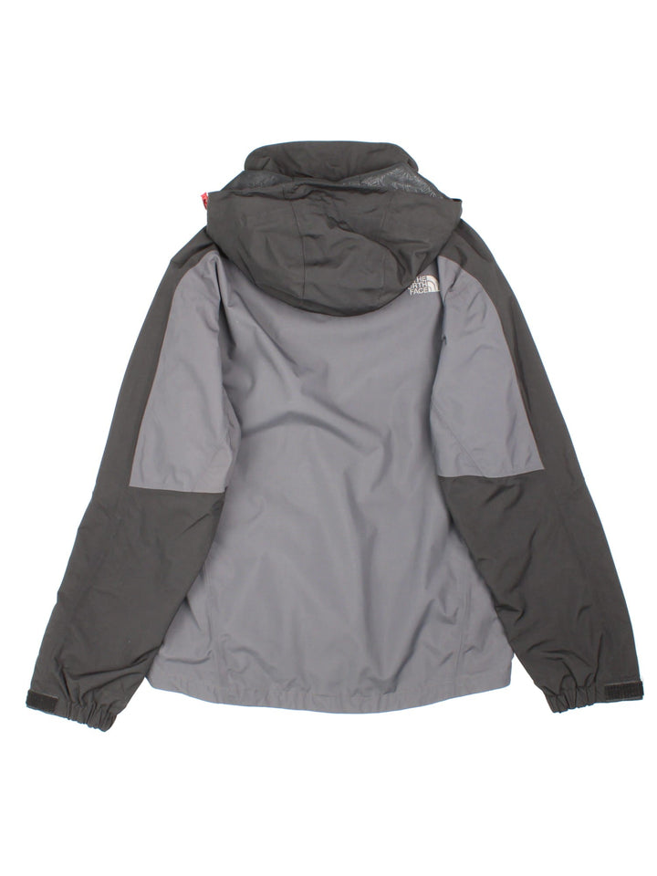 The North Face HyVent hooded jacket in grey with black hood and sleeves, multiple pockets, zip and velcro closure, toggle adjusters at the waist and neck, and embroidered logos on the front and sleeve.