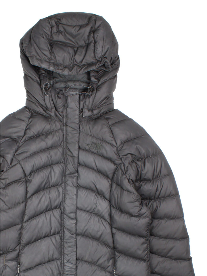 The North Face down filled nano puffer jacket in black with zip and snap closure, two zipped pockets, and embroidered logos front and back.