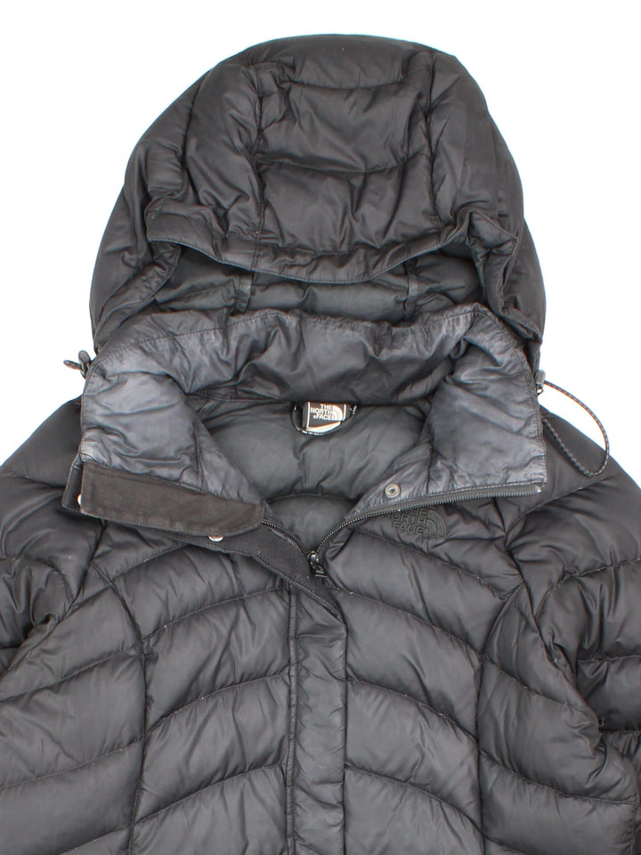 The North Face down filled nano puffer jacket in black with zip and snap closure, two zipped pockets, and embroidered logos front and back.