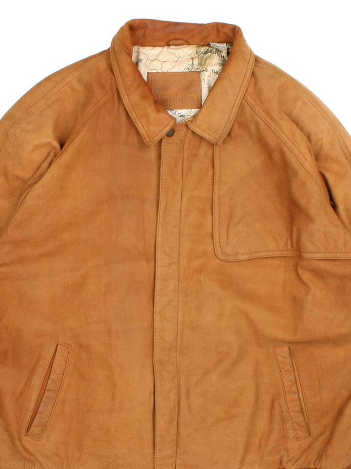 Vintage 90's Marlboro Classics Leather Jacket in a brown colourway. Zips up and has multiple pockets, map design lining, and has arm pads.