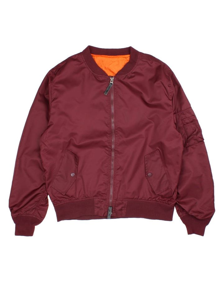 Vintage MA1 Bomber Jacket in a burgundy red colourway with a orange lining. Double zips up and has side pockets.