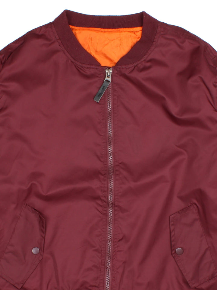 Vintage MA1 Bomber Jacket in a burgundy red colourway with a orange lining. Double zips up and has side pockets.