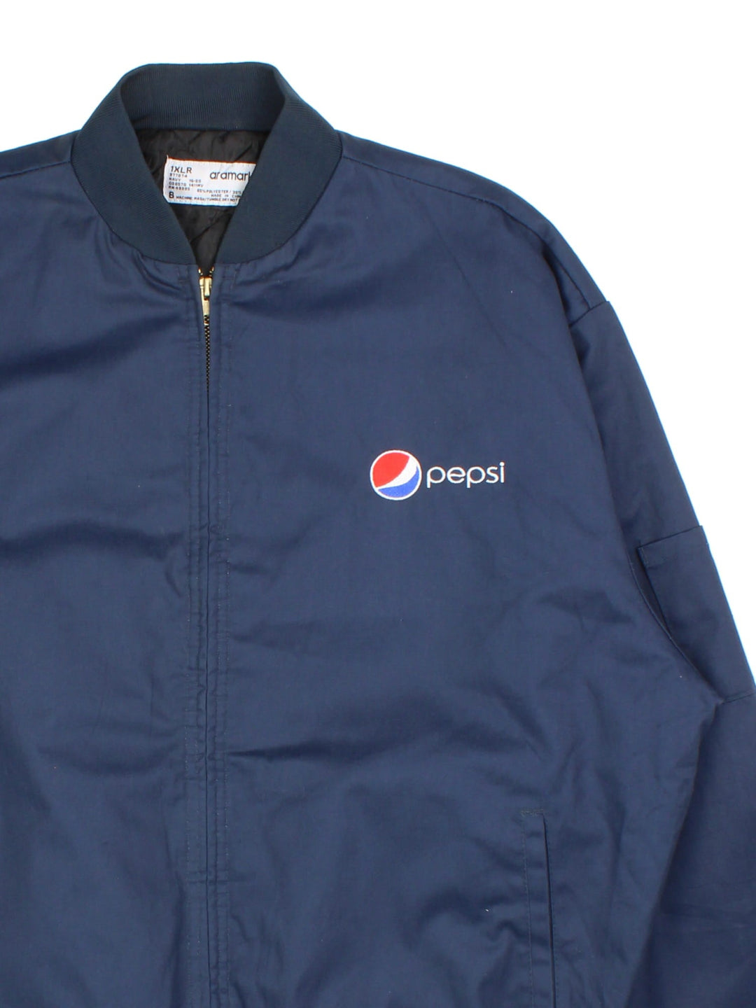 Vintage Pepsi Bomber Jacket By Aramark in a blue colourway. Zips up and has side pockets, insulated with a quilted lining, and has the logo embroidered on the front.