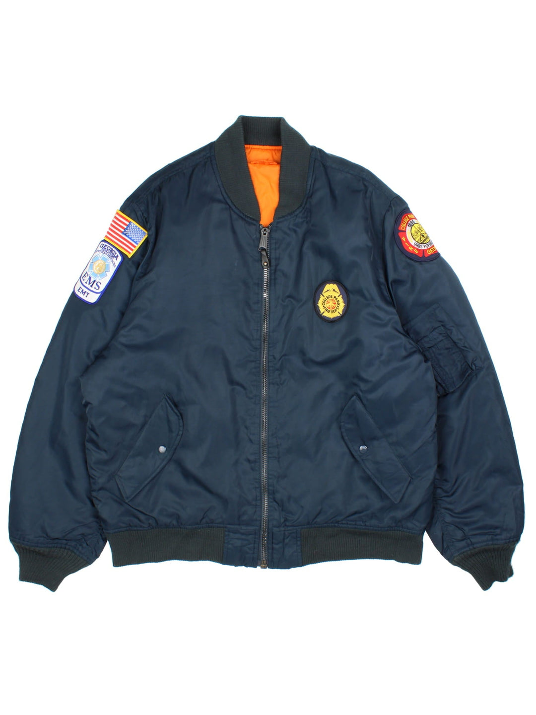 Vintage College Park Fire Department MA1 Reversible Bomber Jacket in either a blue or orange colourway options. Zips up and has side pockets, insulated, and has badge logos embroidered on the front and sleeves.