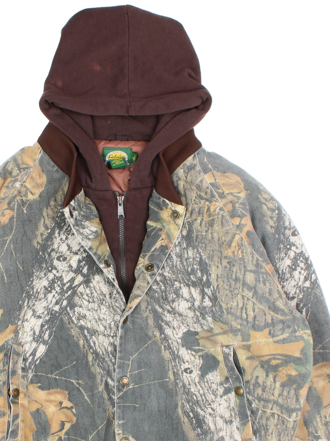 Vintage Cabela's Real Tree Camo Bomber Hunting Jacket in a greenand brown colourway. Zips and buttons up, has side pockets, insulated with a quilted lining, and hooded.