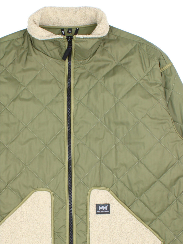 Helly Hansen Quilted Jacket in a green and beige colourway. Zips up and has fleece lined side pockets and collar, insulated lining, and has the logo embroidered on the front.