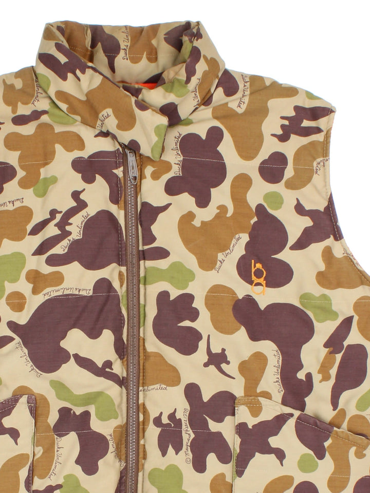 Vintage Reversible Camo Gilet Jacket in either a brown and green camo or orange colourway options. Zips up and has side pockets, insulated lining, and has a embroidered logo on the front.