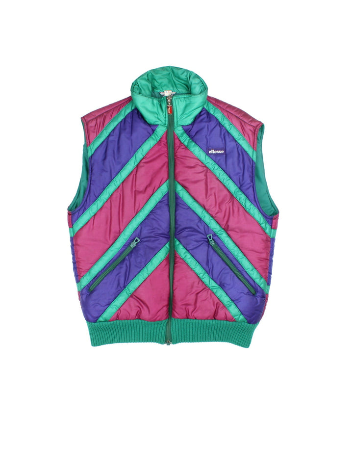 Vintage 90's Ellesse Gilet in a multicoloured colourway. Zips up and has side pockets, insulated lining, and has the logo embroidered on the front.