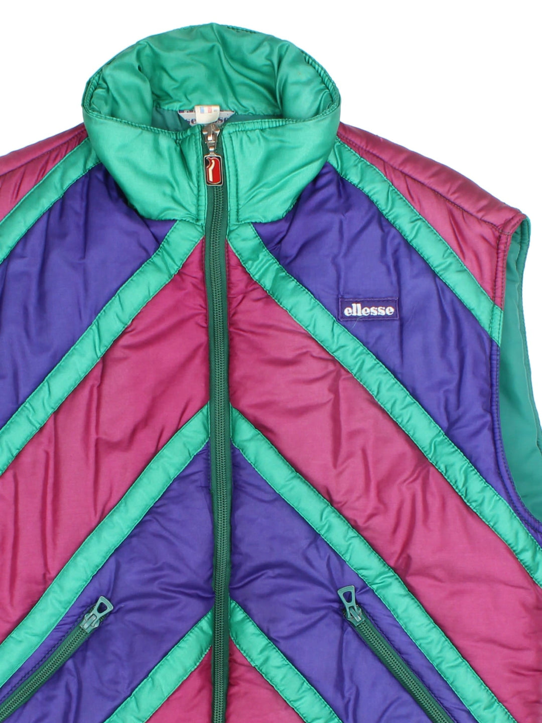 Vintage 90's Ellesse Gilet in a multicoloured colourway. Zips up and has side pockets, insulated lining, and has the logo embroidered on the front.