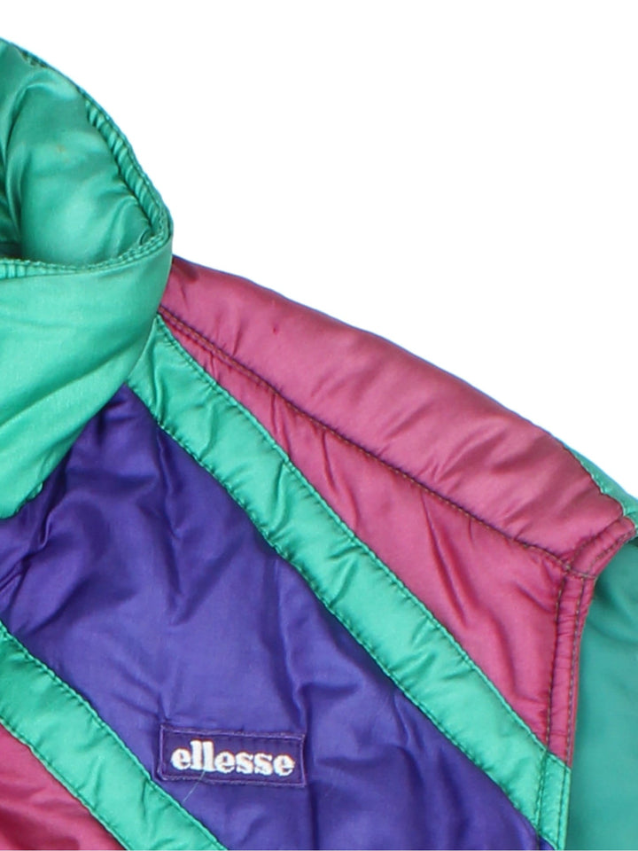 Vintage 90's Ellesse Gilet in a multicoloured colourway. Zips up and has side pockets, insulated lining, and has the logo embroidered on the front.