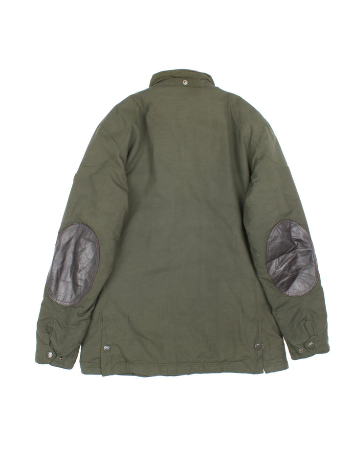 Vintage Barbour International Duke Jacket in a green colourway, popper fastening with x4 front pockets. Slight padding, leather trims and has logo patch on left arm.