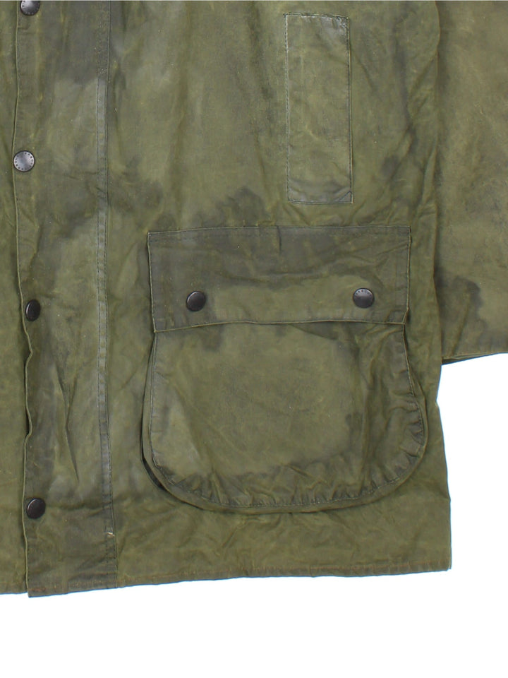 Vintage Barbour Boarder Wax Jacket in a green colourway, popper fastening with x4 front pockets. Contrast cord collar and signature checked lining.