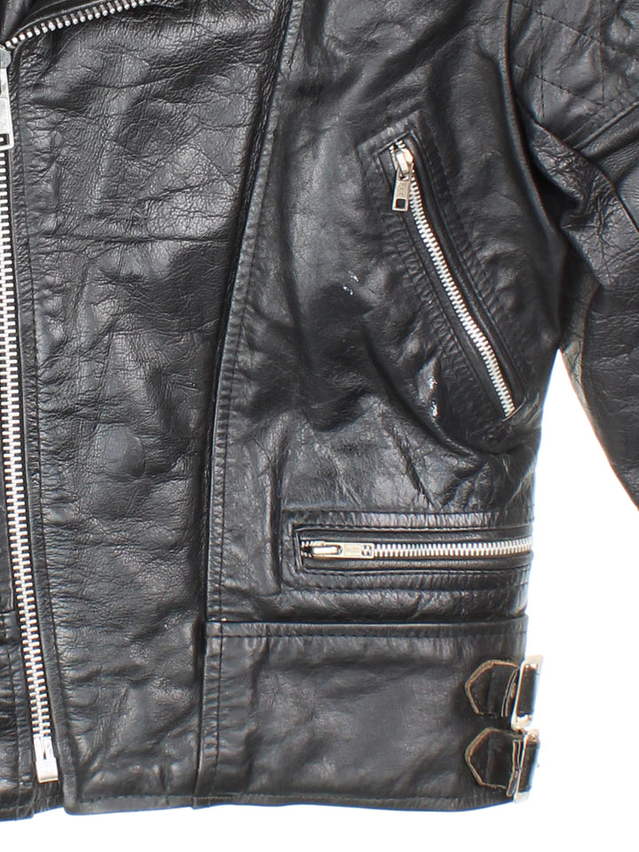 Vintage Leather Biker Jacket in black features zip up pockets, motorcycle detailing, quilted patches and buckle details on the hips.