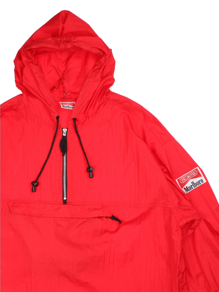 Vintage 90's Marlboro Classics Pullover Windbreaker in a red colourway. Half zip up and has a big pouch pockets, strap feature in the pocket which turns the jacket into a bag, and has the logo badge embroidered on the left sleeve.