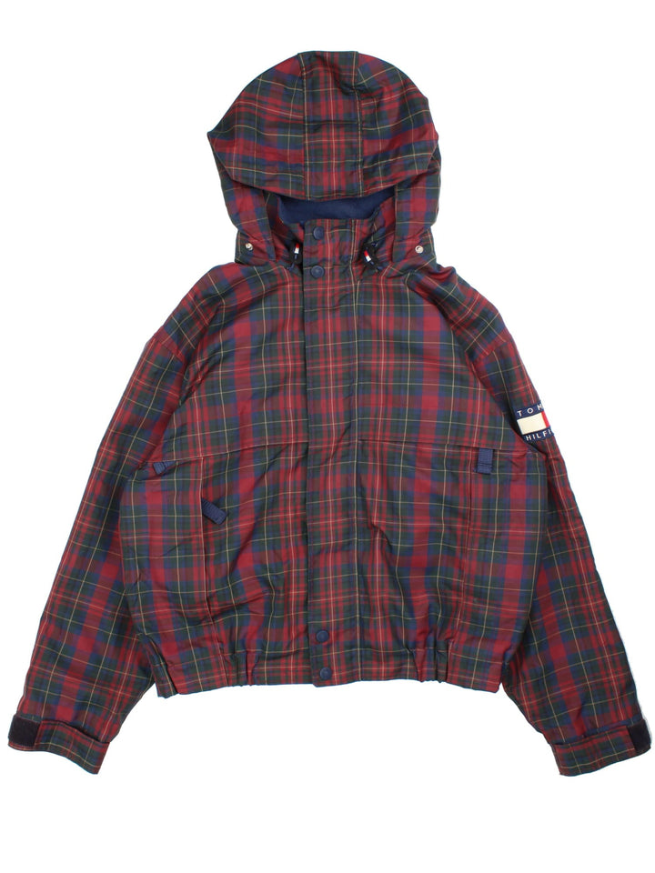 Vintage 90's Tommy Hilfiger Tartan Jacket in a red tartan patterned colourway. Zips up and has multiple pockets, insulated with a fleece lining, and has the logo embroidered on the left sleeve and on the back.