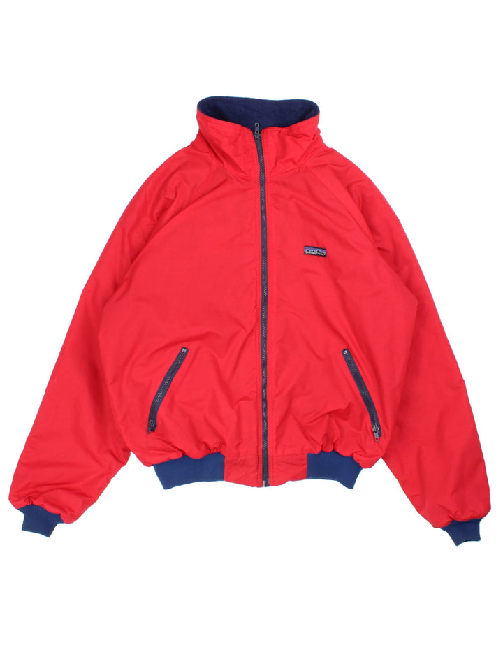 Vintage 90's Patagonia Bomber Jacket in a red colourway. Zips up and has side pockets, insulated with a fleece lining, and has the logo embroidered on the front.