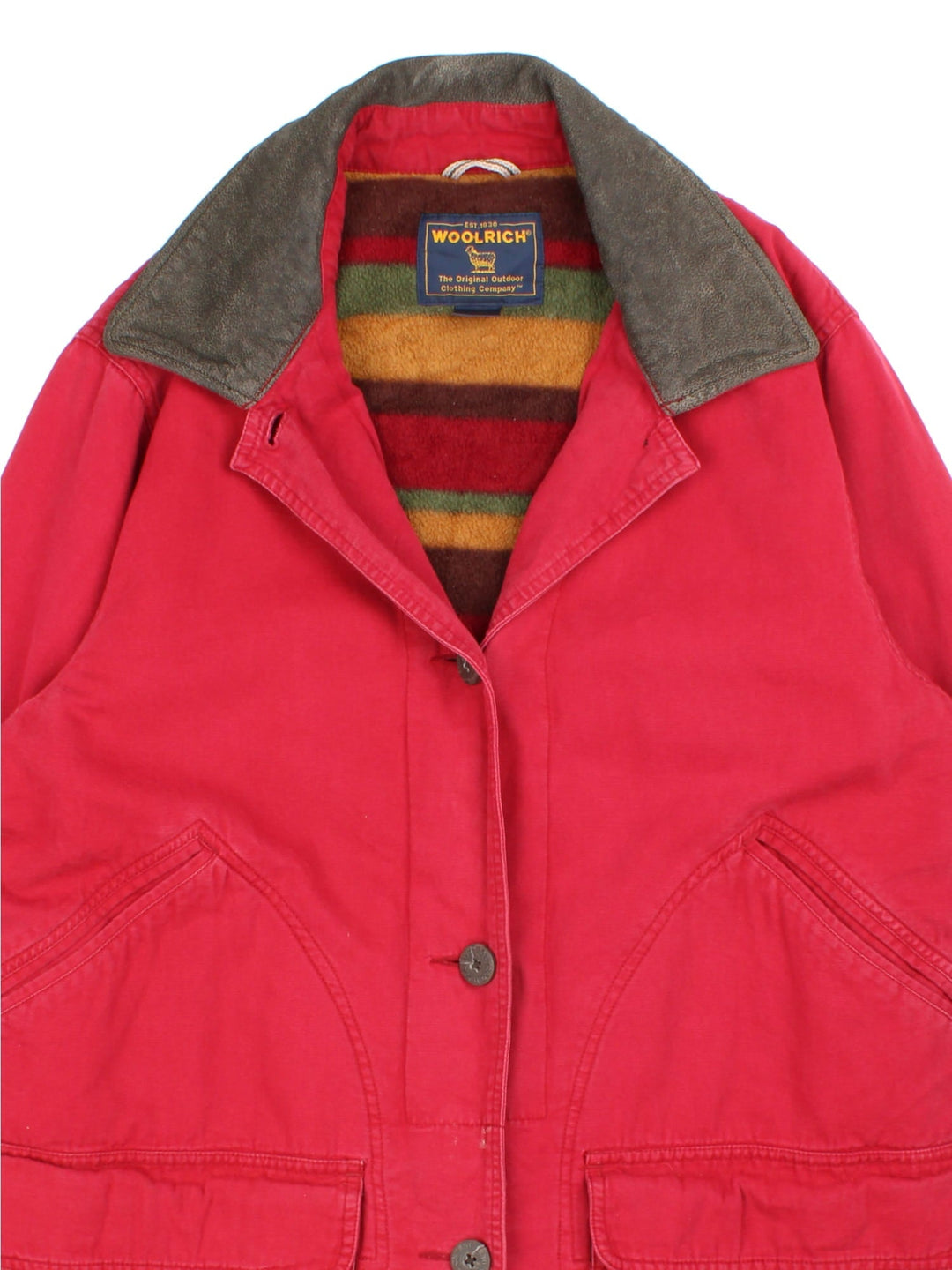 Vintage Woolrich Chore Jacket in a red colourway. Buttons up and has multiple pockets, insulated with a fleece lining, and has the spell out logo embroidered on the left sleeve cuff.