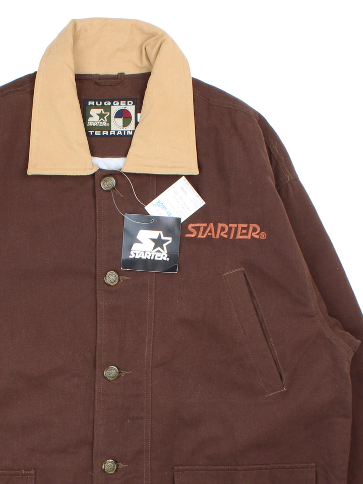 Starter Rugged Terrain Jacket in a brown colourway. Buttons up and has multiple pockets, insulated with a quilted lining, and has the logo embroidered on the front and back.