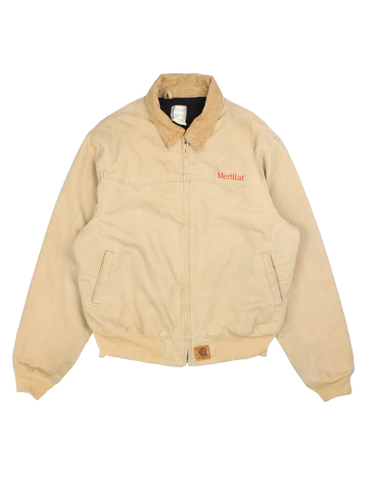 Carhartt Santa Fe Workwear Jacket in a tan colourway. Full zip with suede collar, double pocket on the front and red logo stitching.