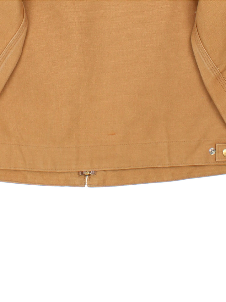 Carhartt Detroit Jacket in a tan colourway. Full zip with multiple pockets on the front. Suede collar, button cuffs and small classic logo on the front.