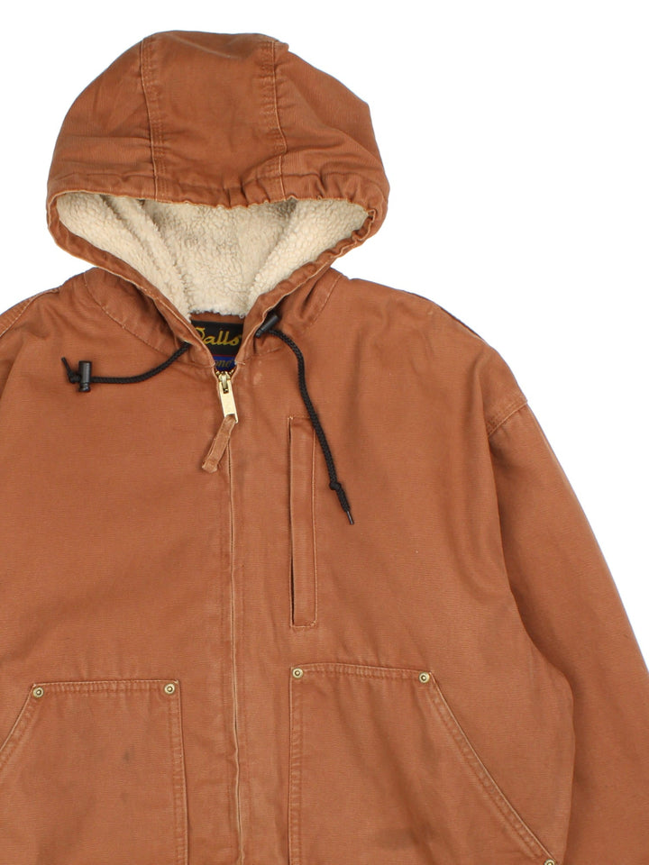 Vintage Walls Workwear Hooded Jacket in a brown colourway. Full zip with fleece lining and double pocket on the front. Cuffed hem and sleeves with a drawstring hood.