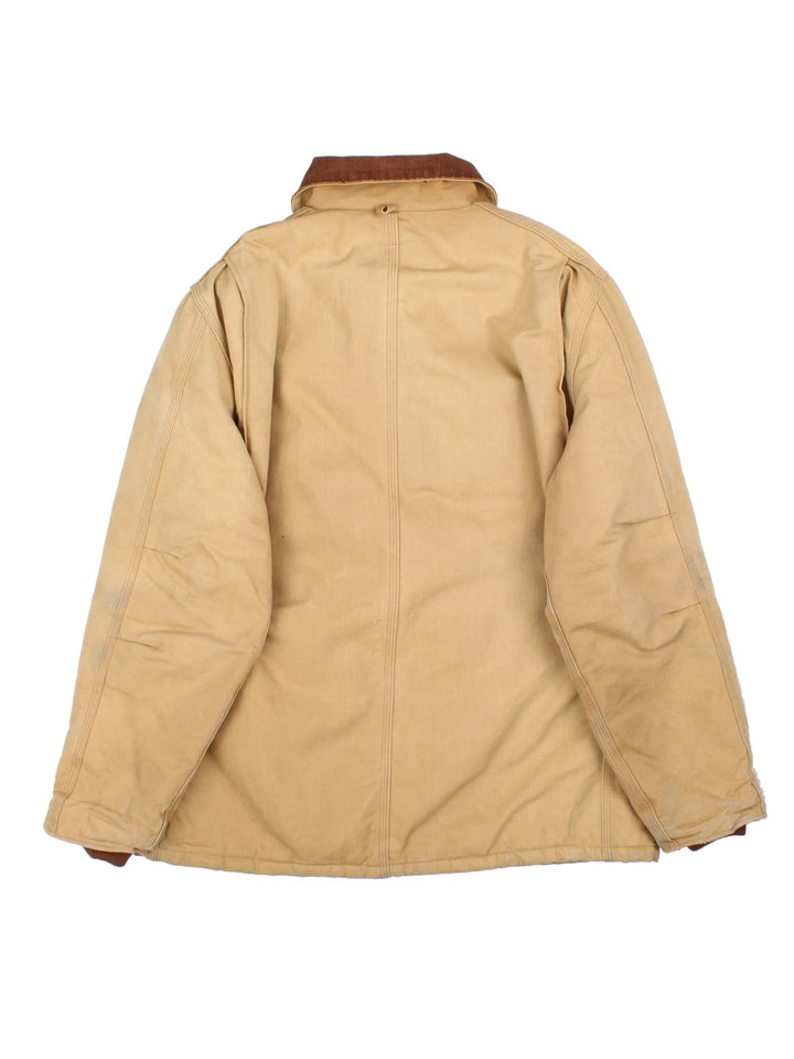 Carhartt Arctic Jacket in a tan colourway. Full zip with multiple large front pockets, suede collar and small classic logo on the front.