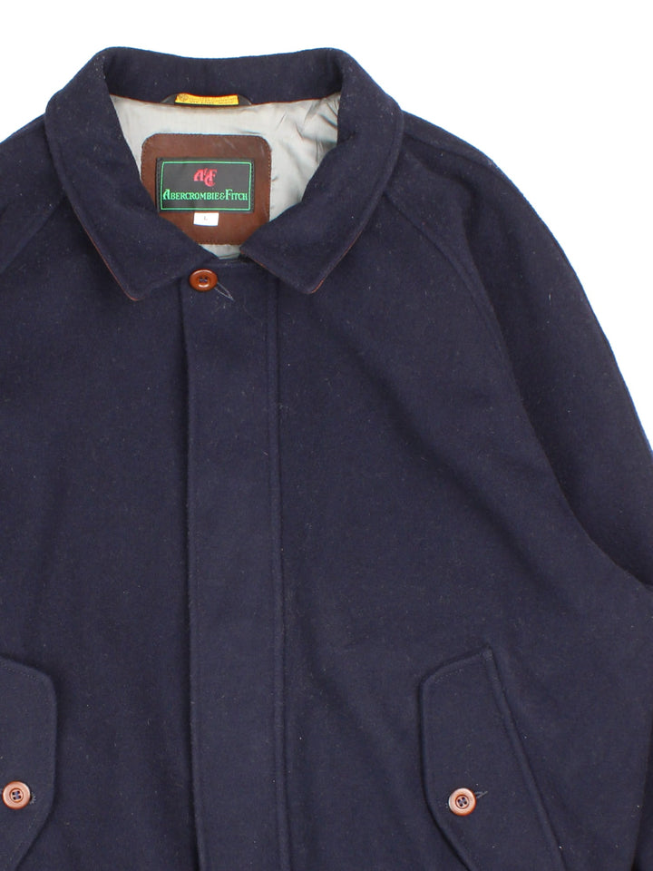 Vintage Abercrombie & Fitch Harrington Jacket in a blue colourway.Full zip with two front button pockets and brown leather detailing on the reverse of collar.